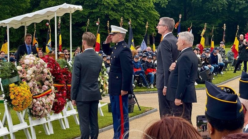 Memorial Day ceremony at Ardennes American Cemetery with a Marine saluting
